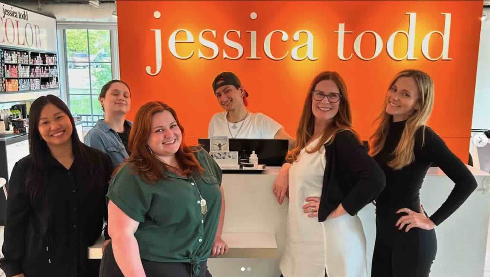 Jessica Todd Hair Salon team members in front of the salon reception, Portsmouth and Durham, NH